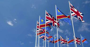 DR Congo and United Kingdom Flags Waving Together in the Sky, Seamless Loop in Wind, Space on Left Side for Design or Information, 3D Rendering video