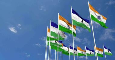 Lesotho and India Flags Waving Together in the Sky, Seamless Loop in Wind, Space on Left Side for Design or Information, 3D Rendering video