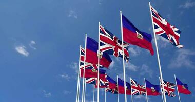 Haiti and United Kingdom Flags Waving Together in the Sky, Seamless Loop in Wind, Space on Left Side for Design or Information, 3D Rendering video