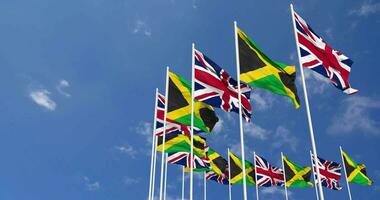 Jamaica and United Kingdom Flags Waving Together in the Sky, Seamless Loop in Wind, Space on Left Side for Design or Information, 3D Rendering video