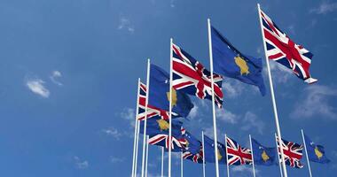 Kosovo and United Kingdom Flags Waving Together in the Sky, Seamless Loop in Wind, Space on Left Side for Design or Information, 3D Rendering video