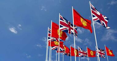 Kyrgyzstan and United Kingdom Flags Waving Together in the Sky, Seamless Loop in Wind, Space on Left Side for Design or Information, 3D Rendering video