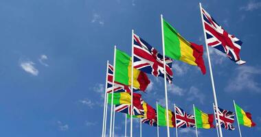 Mali and United Kingdom Flags Waving Together in the Sky, Seamless Loop in Wind, Space on Left Side for Design or Information, 3D Rendering video