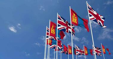 Mongolia and United Kingdom Flags Waving Together in the Sky, Seamless Loop in Wind, Space on Left Side for Design or Information, 3D Rendering video