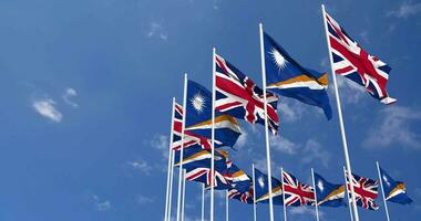 Marshall Islands and United Kingdom Flags Waving Together in the Sky, Seamless Loop in Wind, Space on Left Side for Design or Information, 3D Rendering video