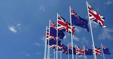 New Zealand and United Kingdom Flags Waving Together in the Sky, Seamless Loop in Wind, Space on Left Side for Design or Information, 3D Rendering video