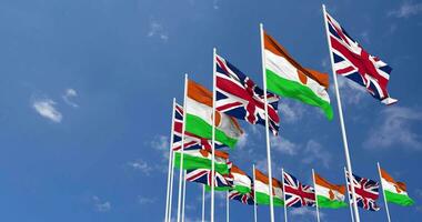 Niger and United Kingdom Flags Waving Together in the Sky, Seamless Loop in Wind, Space on Left Side for Design or Information, 3D Rendering video