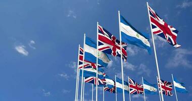 Nicaragua and United Kingdom Flags Waving Together in the Sky, Seamless Loop in Wind, Space on Left Side for Design or Information, 3D Rendering video