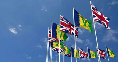 Saint Vincent and the Grenadines and United Kingdom Flags Waving Together in the Sky, Seamless Loop in Wind, Space on Left Side for Design or Information, 3D Rendering video