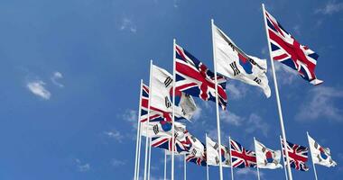 South Korea and United Kingdom Flags Waving Together in the Sky, Seamless Loop in Wind, Space on Left Side for Design or Information, 3D Rendering video