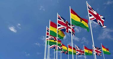 Ghana and United Kingdom Flags Waving Together in the Sky, Seamless Loop in Wind, Space on Left Side for Design or Information, 3D Rendering video