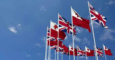 Tonga and United Kingdom Flags Waving Together in the Sky, Seamless Loop in Wind, Space on Left Side for Design or Information, 3D Rendering video