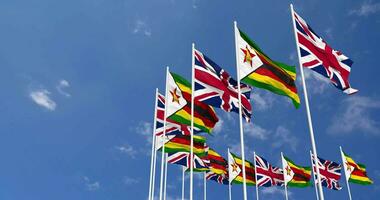 Zimbabwe and United Kingdom Flags Waving Together in the Sky, Seamless Loop in Wind, Space on Left Side for Design or Information, 3D Rendering video