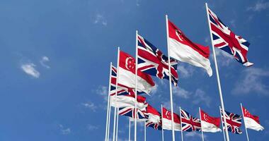 Singapore and United Kingdom Flags Waving Together in the Sky, Seamless Loop in Wind, Space on Left Side for Design or Information, 3D Rendering video