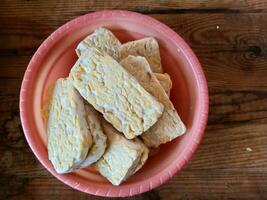 Tempe, Fried Tempe or Fried Tempe is a traditional Indonesian food made from fermented soybeans. Isolated background photo