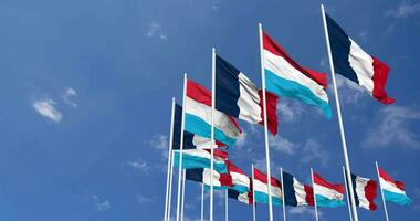 Luxembourg and France Flags Waving Together in the Sky, Seamless Loop in Wind, Space on Left Side for Design or Information, 3D Rendering video