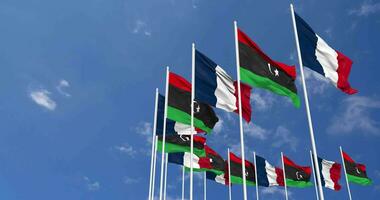 Libya and France Flags Waving Together in the Sky, Seamless Loop in Wind, Space on Left Side for Design or Information, 3D Rendering video