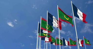 Mauritania and France Flags Waving Together in the Sky, Seamless Loop in Wind, Space on Left Side for Design or Information, 3D Rendering video