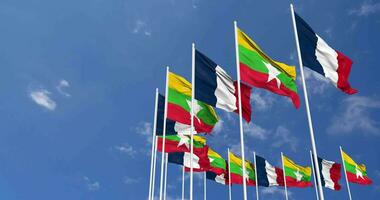 Myanmar, Burma and France Flags Waving Together in the Sky, Seamless Loop in Wind, Space on Left Side for Design or Information, 3D Rendering video