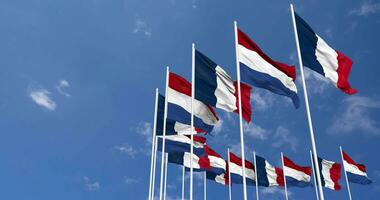 Netherlands and France Flags Waving Together in the Sky, Seamless Loop in Wind, Space on Left Side for Design or Information, 3D Rendering video