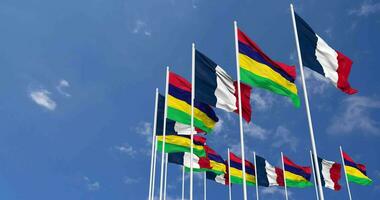 Mauritius and France Flags Waving Together in the Sky, Seamless Loop in Wind, Space on Left Side for Design or Information, 3D Rendering video