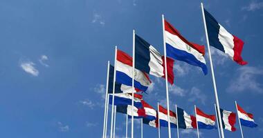 Paraguay and France Flags Waving Together in the Sky, Seamless Loop in Wind, Space on Left Side for Design or Information, 3D Rendering video