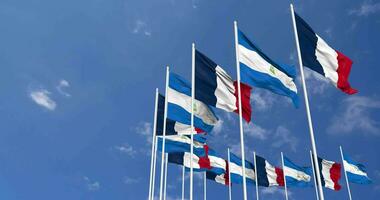 Nicaragua and France Flags Waving Together in the Sky, Seamless Loop in Wind, Space on Left Side for Design or Information, 3D Rendering video