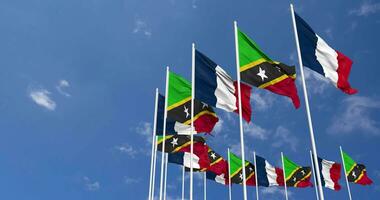 Saint Kitts and Nevis and France Flags Waving Together in the Sky, Seamless Loop in Wind, Space on Left Side for Design or Information, 3D Rendering video