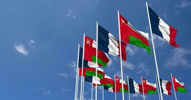 Oman and France Flags Waving Together in the Sky, Seamless Loop in Wind, Space on Left Side for Design or Information, 3D Rendering video