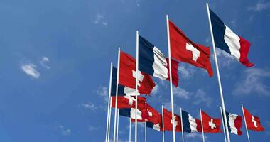 Switzerland and France Flags Waving Together in the Sky, Seamless Loop in Wind, Space on Left Side for Design or Information, 3D Rendering video