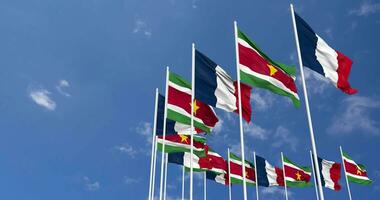 Suriname and France Flags Waving Together in the Sky, Seamless Loop in Wind, Space on Left Side for Design or Information, 3D Rendering video