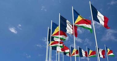 Seychelles and France Flags Waving Together in the Sky, Seamless Loop in Wind, Space on Left Side for Design or Information, 3D Rendering video