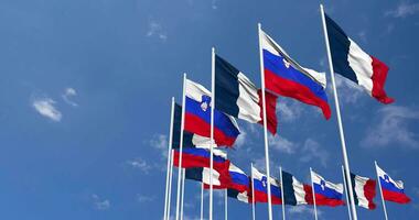 Slovenia and France Flags Waving Together in the Sky, Seamless Loop in Wind, Space on Left Side for Design or Information, 3D Rendering video