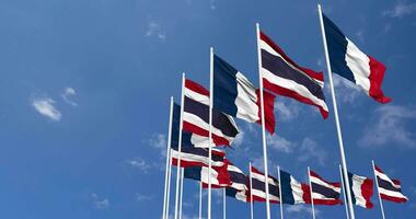 Thailand and France Flags Waving Together in the Sky, Seamless Loop in Wind, Space on Left Side for Design or Information, 3D Rendering video