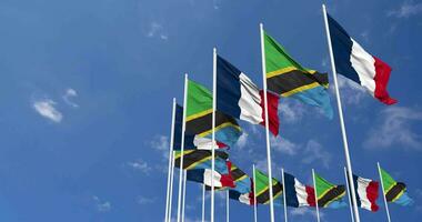 Tanzania and France Flags Waving Together in the Sky, Seamless Loop in Wind, Space on Left Side for Design or Information, 3D Rendering video