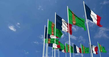 Turkmenistan and France Flags Waving Together in the Sky, Seamless Loop in Wind, Space on Left Side for Design or Information, 3D Rendering video