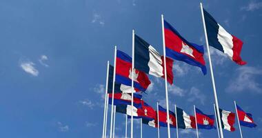 Cambodia and France Flags Waving Together in the Sky, Seamless Loop in Wind, Space on Left Side for Design or Information, 3D Rendering video