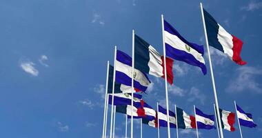 El Salvador and France Flags Waving Together in the Sky, Seamless Loop in Wind, Space on Left Side for Design or Information, 3D Rendering video