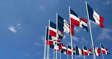 dominicano república y Francia banderas ondulación juntos en el cielo, sin costura lazo en viento, espacio en izquierda lado para diseño o información, 3d representación video
