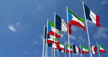 Equatorial Guinea and France Flags Waving Together in the Sky, Seamless Loop in Wind, Space on Left Side for Design or Information, 3D Rendering video