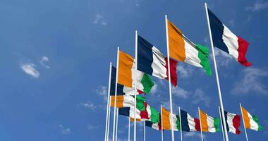 Ivory Coast and France Flags Waving Together in the Sky, Seamless Loop in Wind, Space on Left Side for Design or Information, 3D Rendering video