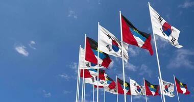 Antigua and Barbuda and South Korea Flags Waving Together in the Sky, Seamless Loop in Wind, Space on Left Side for Design or Information, 3D Rendering video