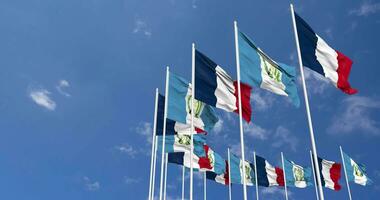 Guatemala and France Flags Waving Together in the Sky, Seamless Loop in Wind, Space on Left Side for Design or Information, 3D Rendering video