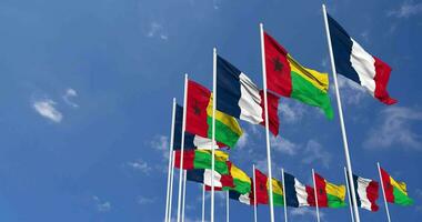 Guinea Bissau and France Flags Waving Together in the Sky, Seamless Loop in Wind, Space on Left Side for Design or Information, 3D Rendering video