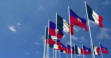 Haiti and France Flags Waving Together in the Sky, Seamless Loop in Wind, Space on Left Side for Design or Information, 3D Rendering video