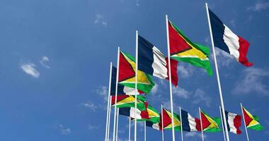 Guyana and France Flags Waving Together in the Sky, Seamless Loop in Wind, Space on Left Side for Design or Information, 3D Rendering video