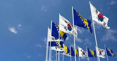 Bósnia e herzegovina e sul Coréia bandeiras acenando juntos dentro a céu, desatado ciclo dentro vento, espaço em esquerda lado para Projeto ou Informação, 3d Renderização video