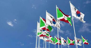 Burundi and South Korea Flags Waving Together in the Sky, Seamless Loop in Wind, Space on Left Side for Design or Information, 3D Rendering video