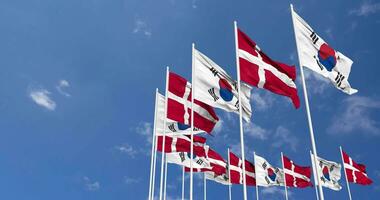 Denmark and South Korea Flags Waving Together in the Sky, Seamless Loop in Wind, Space on Left Side for Design or Information, 3D Rendering video