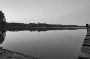 View over a lake in Sweden in Smalland with forest on the other shore. Wild nature photo